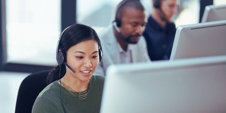A managed services team work on their computers